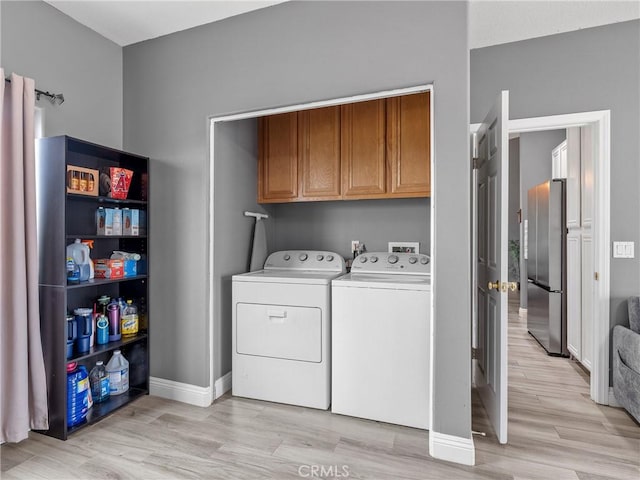 22132 Esaws Rd, Apple Valley, CA 92307 - washroom with cabinet space, washing machine and clothes dryer, light wood-type flooring, and baseboards