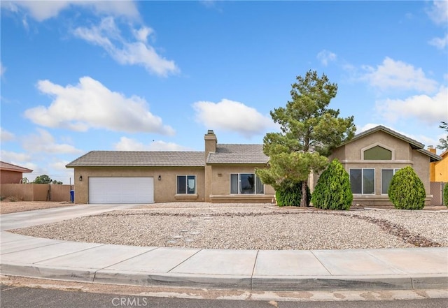 22132 Esaws Rd, Apple Valley, CA 92307 - view of front of home with concrete driveway, a chimney, a garage, stucco siding, and a tile roof