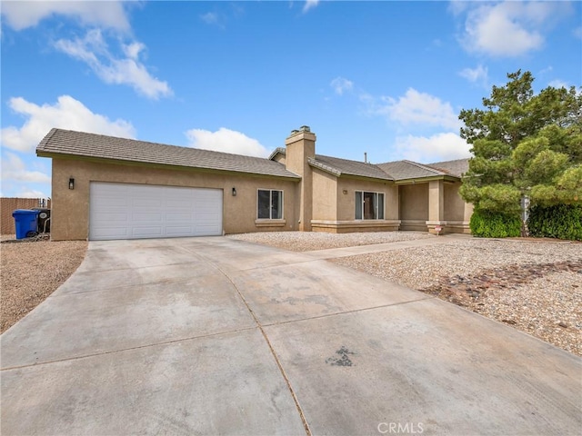 22132 Esaws Rd, Apple Valley, CA 92307 - ranch-style home with concrete driveway, stucco siding, a garage, and a chimney