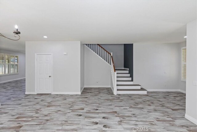 8433 Lindenhurst St, Riverside, CA 92508 - unfurnished living room featuring wood finished floors, recessed lighting, and stairs