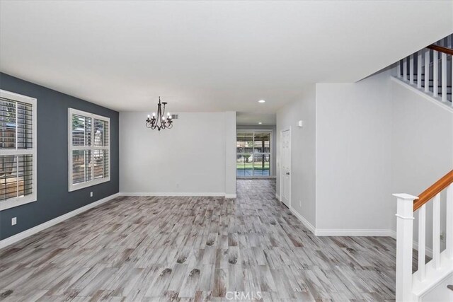 8433 Lindenhurst St, Riverside, CA 92508 - empty room with stairs, wood finished floors, a chandelier, and recessed lighting