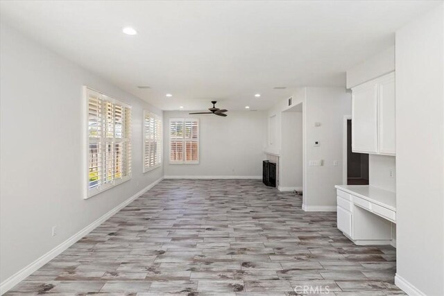 8433 Lindenhurst St, Riverside, CA 92508 - unfurnished living room with ceiling fan, recessed lighting, light wood-style floors, and a fireplace