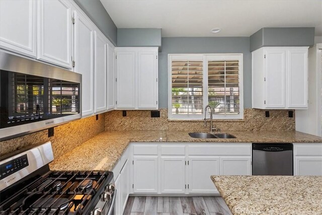 8433 Lindenhurst St, Riverside, CA 92508 - kitchen featuring appliances with stainless steel finishes, light wood finished floors, and white cabinetry