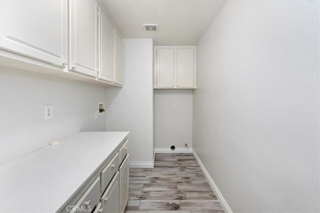 8433 Lindenhurst St, Riverside, CA 92508 - laundry area with cabinet space, washer hookup, and light wood finished floors