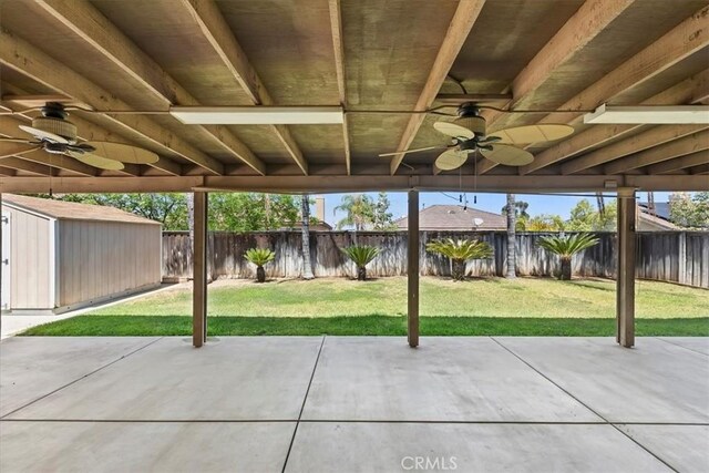 8433 Lindenhurst St, Riverside, CA 92508 - fenced backyard with a ceiling fan, a storage unit, and a patio