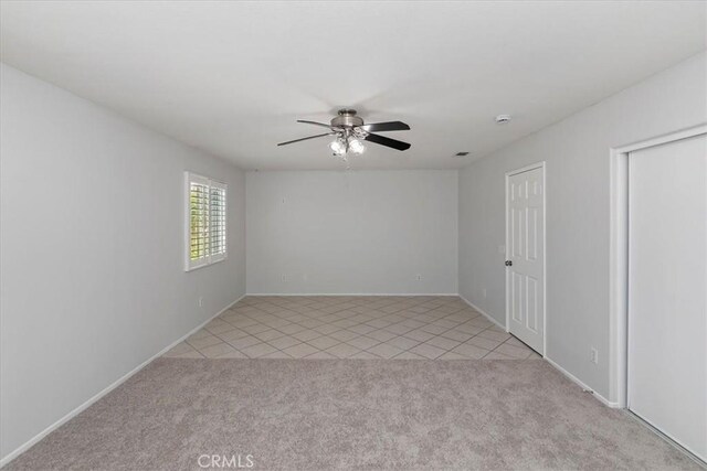 8433 Lindenhurst St, Riverside, CA 92508 - spare room with a ceiling fan, light carpet, and light tile patterned floors