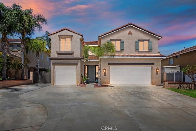 8433 Lindenhurst St, Riverside, CA 92508 - mediterranean / spanish home featuring an attached garage, concrete driveway, stucco siding, and a tiled roof