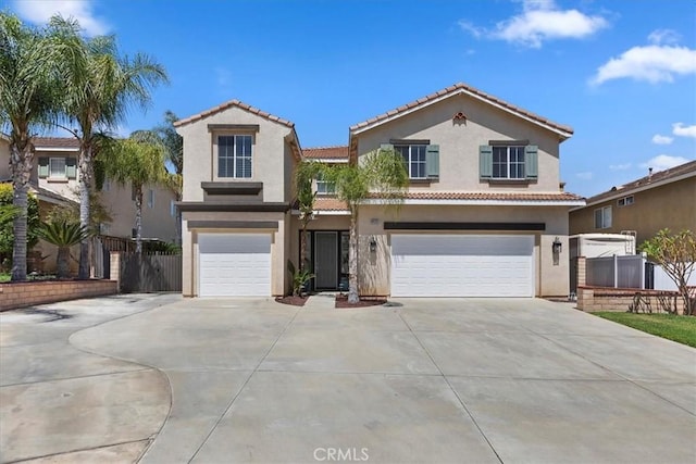 8433 Lindenhurst St, Riverside, CA 92508 - mediterranean / spanish-style house featuring an attached garage, driveway, stucco siding, and a tile roof
