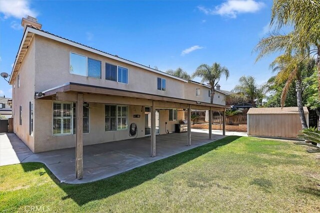 8433 Lindenhurst St, Riverside, CA 92508 - back of house with stucco siding, a shed, a patio, and a chimney
