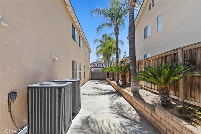 8433 Lindenhurst St, Riverside, CA 92508 - view of side of home featuring stucco siding, a fenced backyard, and a patio area