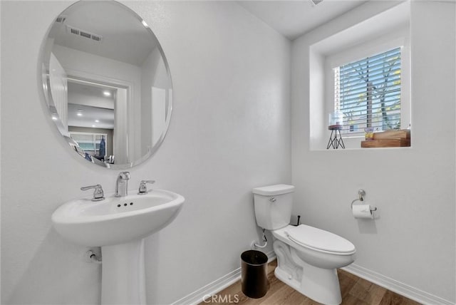 16548 Monteviejo St, Fontana, CA 92336 - half bathroom with wood finished floors, baseboards, and toilet