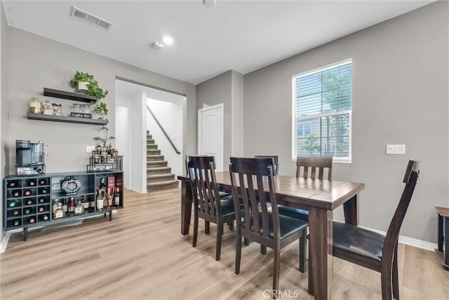 16548 Monteviejo St, Fontana, CA 92336 - dining room featuring light wood-style floors, stairs, and baseboards