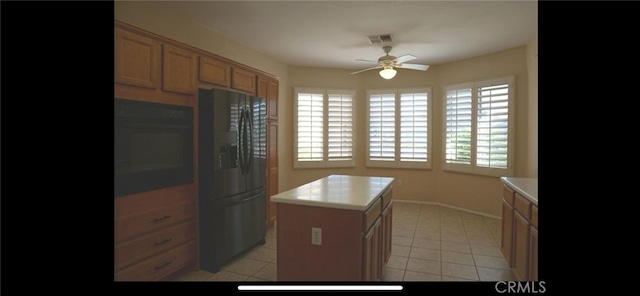 78379 Kistler Way, Palm Desert, CA 92211 - kitchen featuring black appliances, a ceiling fan, light countertops, and a center island