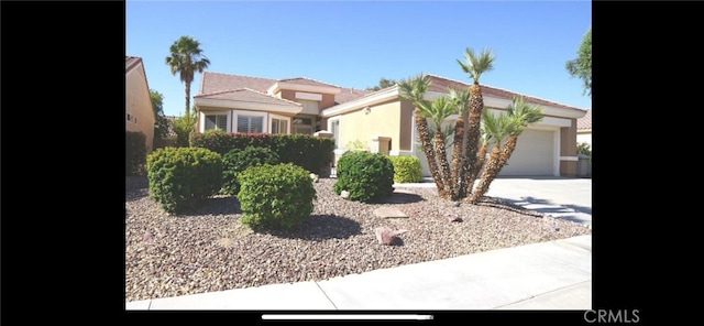 78379 Kistler Way, Palm Desert, CA 92211 - view of front of house featuring concrete driveway, an attached garage, and stucco siding