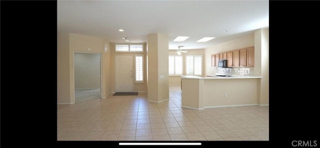 78379 Kistler Way, Palm Desert, CA 92211 - kitchen with black microwave, light countertops, light tile patterned floors, recessed lighting, and decorative backsplash