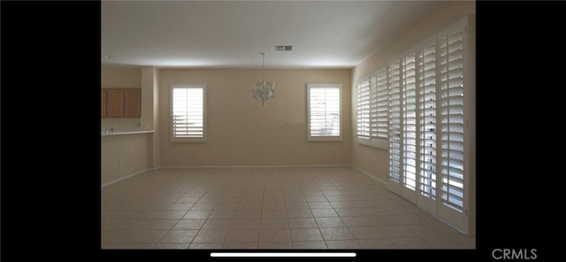78379 Kistler Way, Palm Desert, CA 92211 - unfurnished dining area with plenty of natural light, light tile patterned flooring, and baseboards