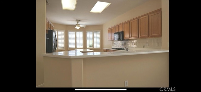 78379 Kistler Way, Palm Desert, CA 92211 - kitchen featuring black microwave, tasteful backsplash, refrigerator, a ceiling fan, and light countertops