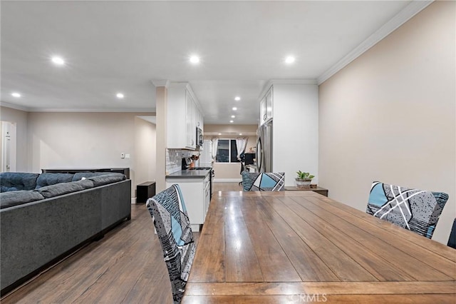 14725 Kornblum Ave, Hawthorne, CA 90250 - dining area with dark wood-style flooring, recessed lighting, and crown molding