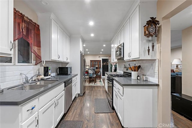 14725 Kornblum Ave, Hawthorne, CA 90250 - kitchen with appliances with stainless steel finishes, a sink, dark countertops, dark wood-style flooring, and recessed lighting