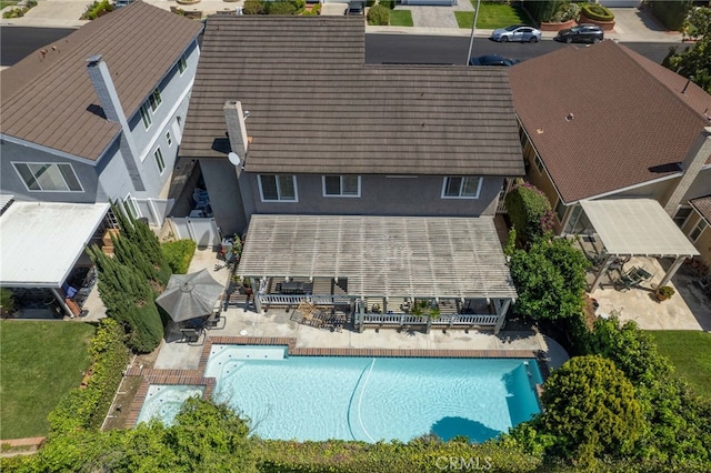 view of subject property with a pool