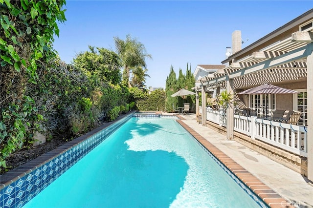 view of pool featuring a patio, a pergola, a fenced backyard, and a pool with connected hot tub