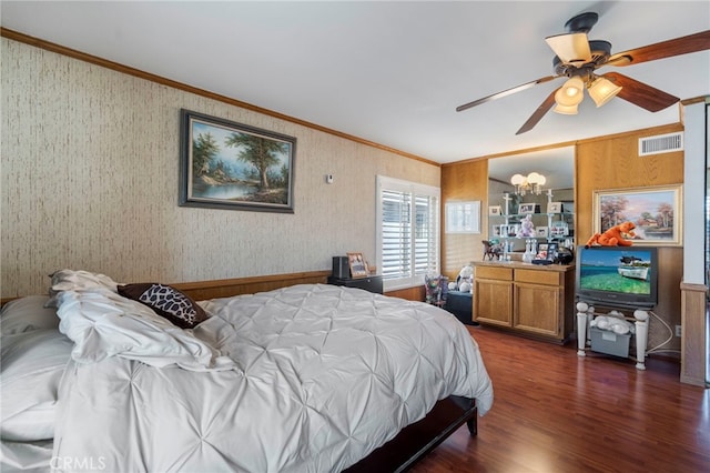 bedroom with crown molding, dark wood-style floors, and wallpapered walls
