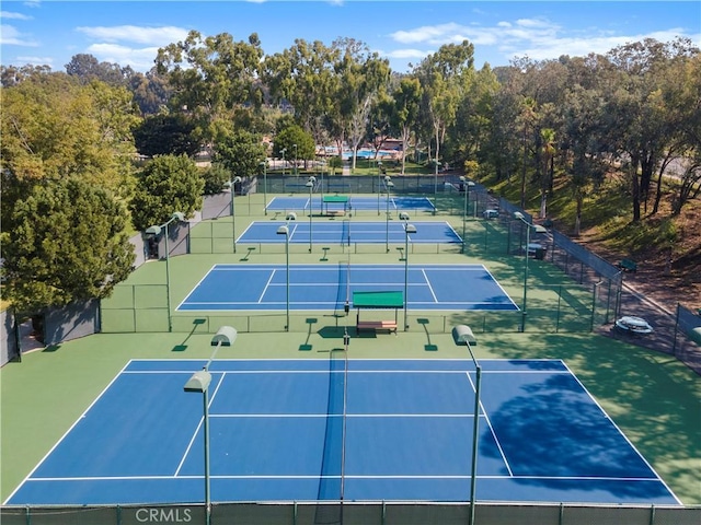 view of tennis court featuring fence