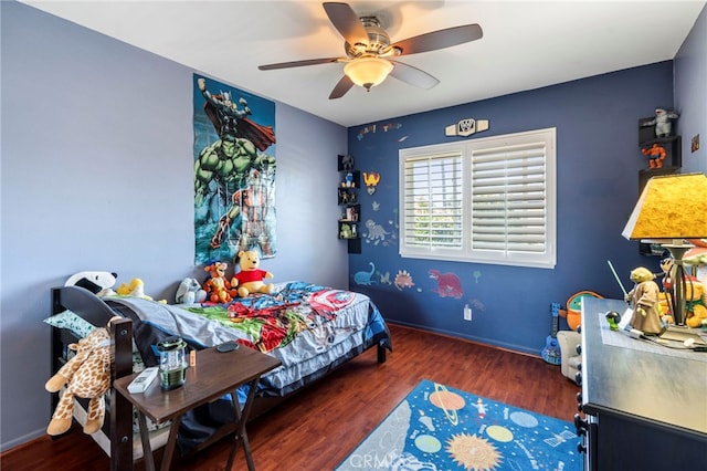 bedroom with wood finished floors, a ceiling fan, and baseboards