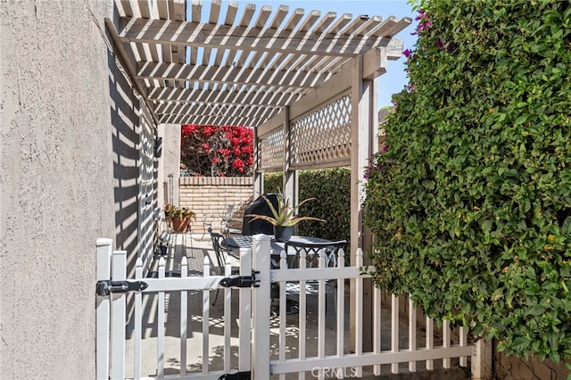 wooden deck featuring fence, a gate, and a pergola