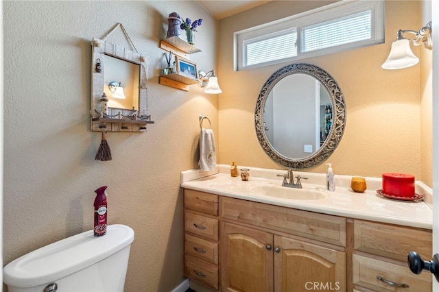 bathroom featuring toilet and vanity