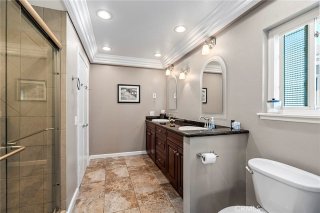 bathroom with ornamental molding, toilet, baseboards, a tile shower, and double vanity