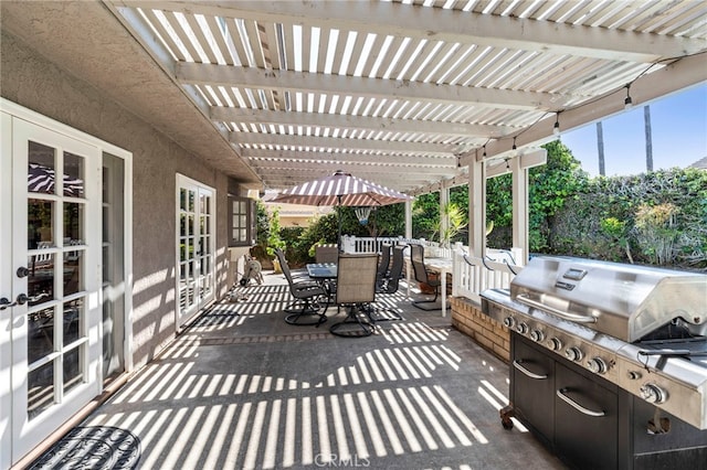 view of patio / terrace featuring outdoor dining area, a pergola, and area for grilling