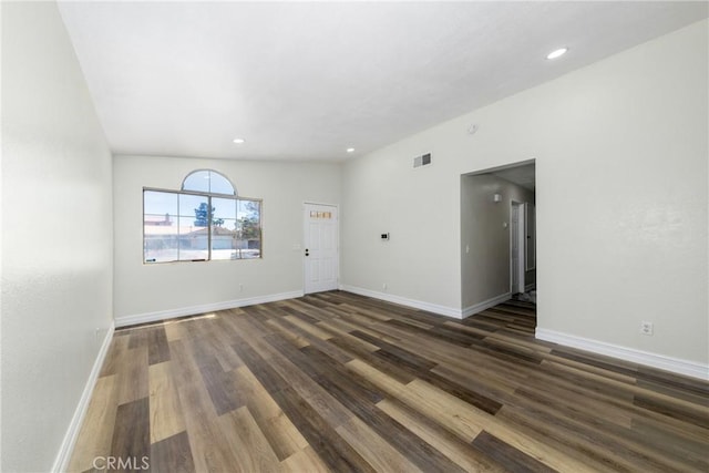 unfurnished living room featuring wood finished floors, baseboards, and recessed lighting