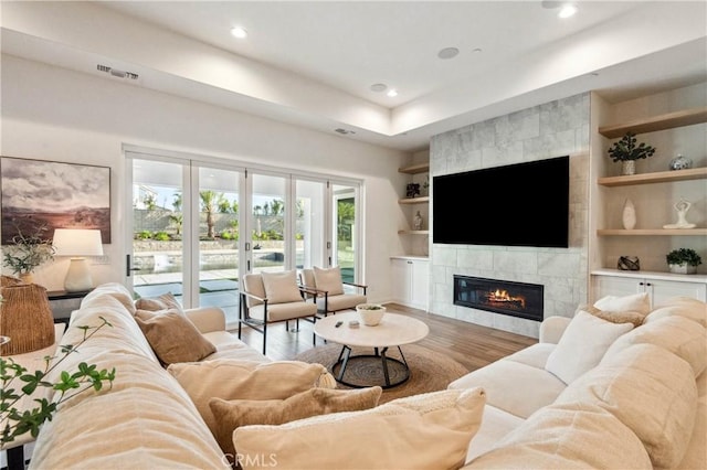 17550 Bretton Woods Pl, Riverside, CA 92504 - living area featuring a fireplace, wood finished floors, built in shelves, recessed lighting, and baseboards