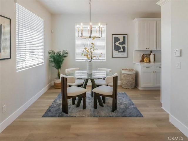 613 E Walnut Ave, Monrovia, CA 91016 - dining space with a chandelier, baseboards, and light wood-style floors