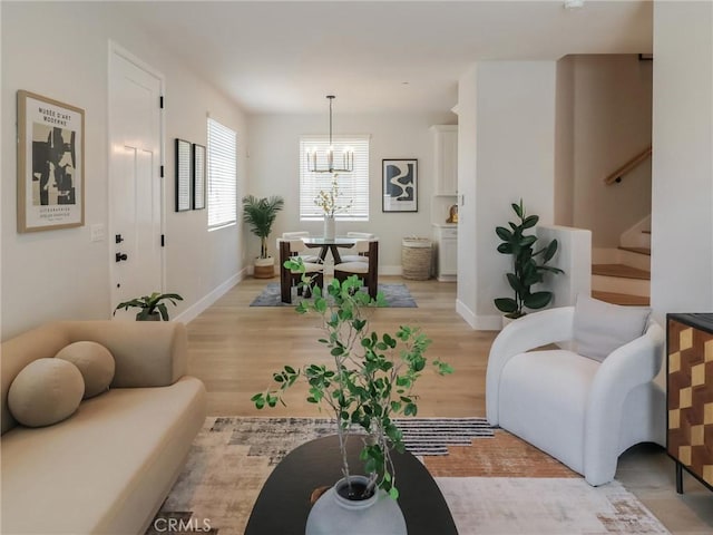 613 E Walnut Ave, Monrovia, CA 91016 - living area featuring a chandelier, stairway, light wood-type flooring, and baseboards