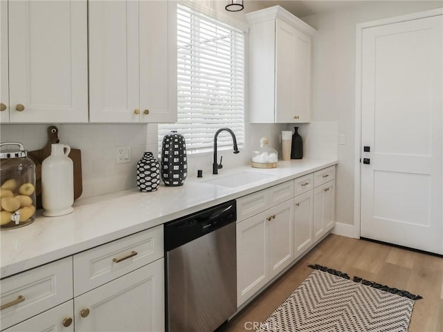 613 E Walnut Ave, Monrovia, CA 91016 - kitchen with stainless steel dishwasher, a sink, backsplash, and white cabinetry