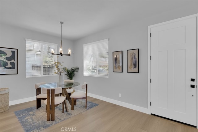 613 E Walnut Ave, Monrovia, CA 91016 - dining room featuring wood finished floors, a chandelier, and healthy amount of natural light