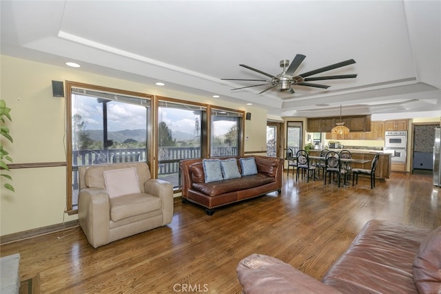 24300 Sylvan Glen Rd, Calabasas, CA 91302 - living room featuring a raised ceiling, ceiling fan, wood finished floors, and recessed lighting