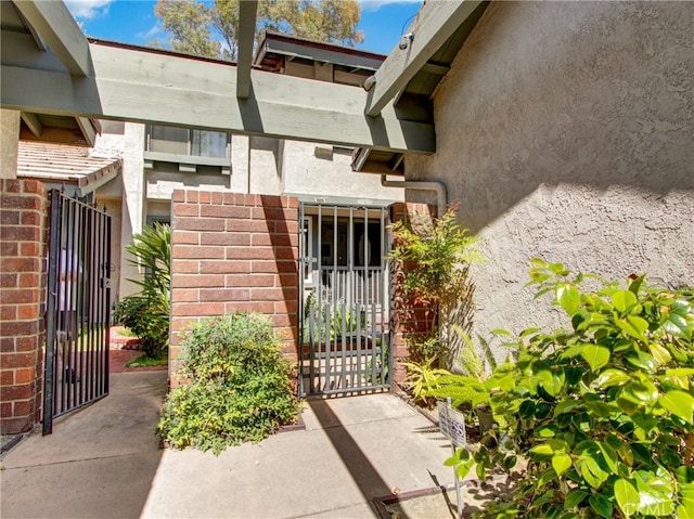 6587 E Via Fresco, Anaheim Hills, CA 92807 - doorway to property with a gate and stucco siding