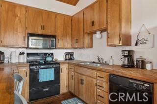 859 Poe Ct, Lake Arrowhead, CA 92352 - kitchen with black appliances and brown cabinets