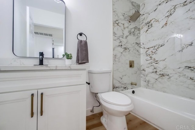 full bathroom featuring toilet, vanity, shower / tub combination, and wood finished floors