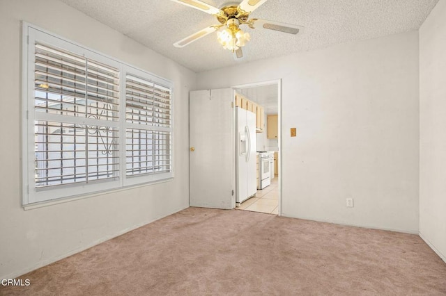 2575 Gayle Pl, Simi Valley, CA 93065 - unfurnished bedroom with white refrigerator with ice dispenser, light carpet, a textured ceiling, and a ceiling fan