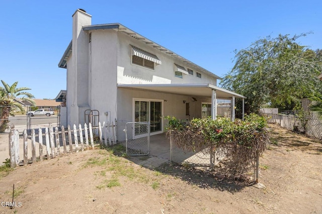 2575 Gayle Pl, Simi Valley, CA 93065 - back of property featuring a chimney, stucco siding, and a patio