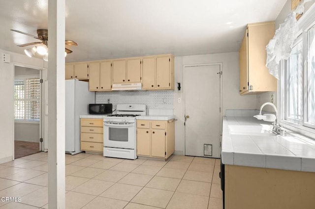 2575 Gayle Pl, Simi Valley, CA 93065 - kitchen featuring white appliances, under cabinet range hood, tile countertops, a sink, and cream cabinetry