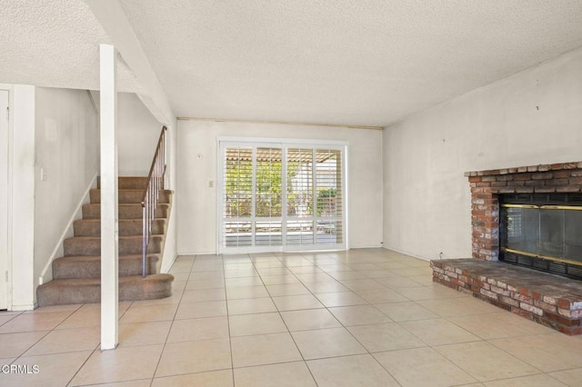 2575 Gayle Pl, Simi Valley, CA 93065 - unfurnished living room with stairway, a textured ceiling, a fireplace, light tile patterned flooring, and baseboards