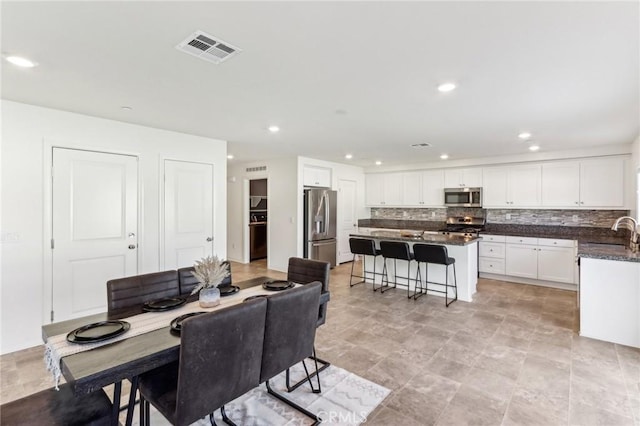 29586 Bisbee Ct, Winchester, CA 92596 - dining space with recessed lighting and stone finish floors