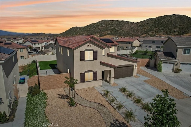 29586 Bisbee Ct, Winchester, CA 92596 - view of front of house with a mountain view, stucco siding, concrete driveway, a residential view, and a fenced backyard
