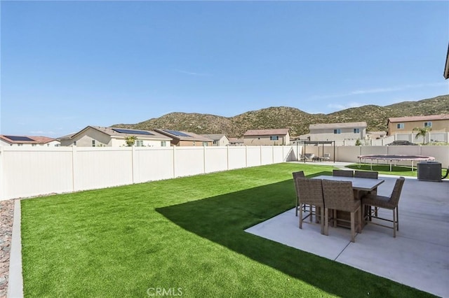 29586 Bisbee Ct, Winchester, CA 92596 - view of yard featuring a trampoline, a patio area, a mountain view, and outdoor dining space