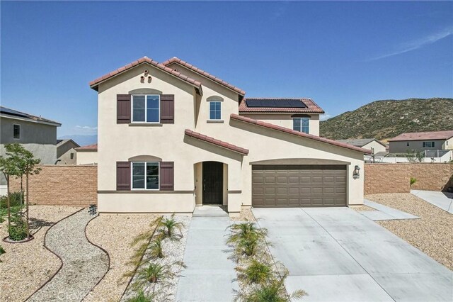 29586 Bisbee Ct, Winchester, CA 92596 - mediterranean / spanish-style house with stucco siding, driveway, roof mounted solar panels, a tiled roof, and a mountain view